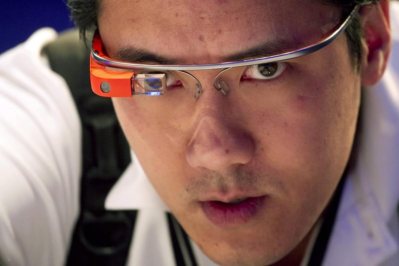 Vincent Nguyen of SlashGear wears a Google Glass while covering the introduction of the Microsoft Surface 2 in September. Mark Lennihan / AP Photo