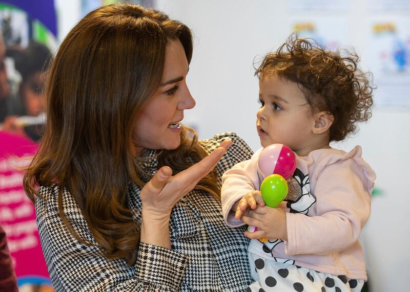 The Duchess talks with 18-month-old Sorayah Ahmad during a visit to a Khidmat Centre in Bradford. AP