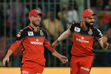 (FILES) In this file photo taken on April 24, 2019, Royal Challengers Bangalore captain Virat Kohli (R) and team mate AB De Villiers celebrate the dismissal of Kings XI Punjab captain and batsman Ravichandran Ashwin for 6 runs during the 2019 Indian Premier League (IPL) Twenty20 cricket match between Royal Challengers Bangalore and Kings XI Punjab at the M. Chinnaswamy Stadium, in Bangalore. South African veteran AB de Villiers says wooden spooners Royal Challengers Bangalore is showing a lot of promise for the upcoming IPL season, praising skipper Virat Kohli for his leadership in driving the team's preparations. - IMAGE RESTRICTED TO EDITORIAL USE - STRICTLY NO COMMERCIAL USE / AFP / Manjunath KIRAN / IMAGE RESTRICTED TO EDITORIAL USE - STRICTLY NO COMMERCIAL USE