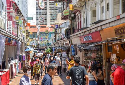 Beyond the high rises of Singapore are handcrafted signs and Chinese goods in Chinatown. Photo: Ronan O'Connell