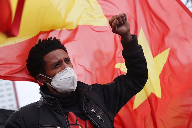 BERLIN, GERMANY - MAY 07: A protester raises his fist during a demonstration against Ethiopia's war against Tigray regional forces near the Chinese Embassy on May 07, 2021 in Berlin, Germany. The protesters were also demanding the Chinese government stop supporting the Ethiopian government. The Tigray War began in 2020 and is ongoing. (Photo by Sean Gallup/Getty Images)