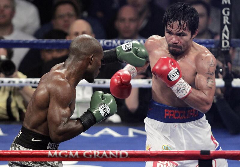 Manny Pacquiao (R) of the Philippines measures Timothy Bradley (L) of the US during their WBO welterweight title fight on April 12, 2014 at the MGM Grand Garden Arena in Las Vegas, Nevada.     Pacquiao  won a 12-round unanimous decision over Bradley to avenge his controversial 2012 loss to the previously unbeaten American. AFP PHOTO / John Gurzinski (Photo by JOHN GURZINSKI / AFP)