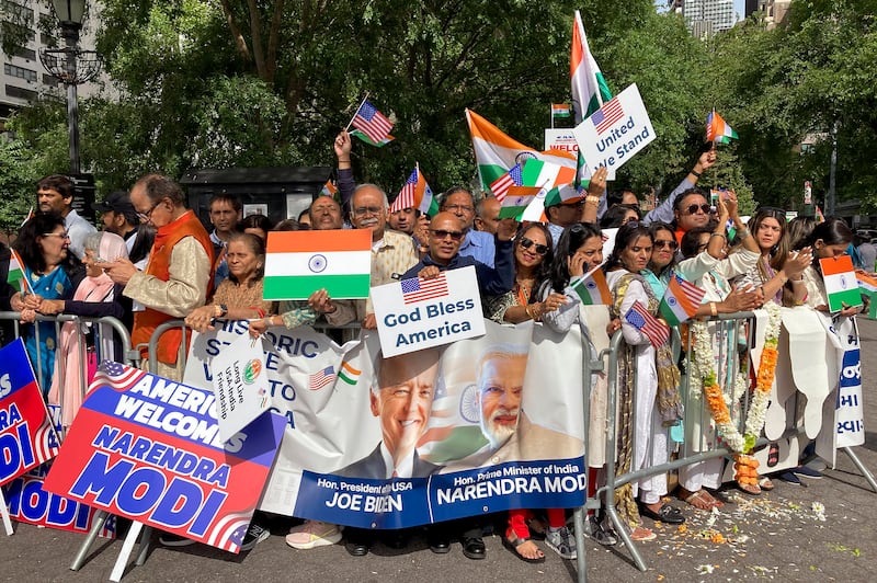 People gather near UN headquarters to welcome Mr Modi. AP