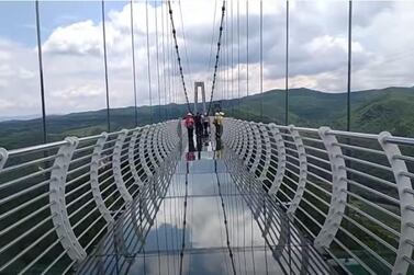 The Longjing glass-bottom bridge was damaged by 145-kilometre-per-hour winds, leaving a tourist clinging on for life. Courtesy YouTube