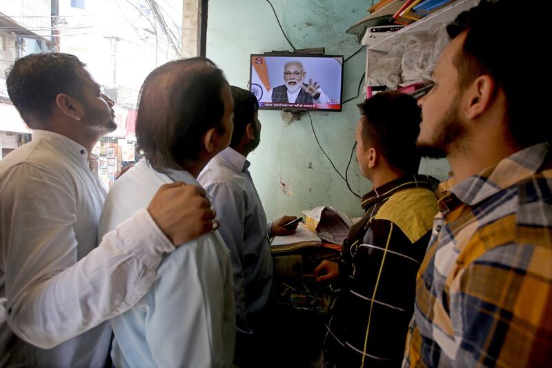 epaselect epa07466367 Indian people watch Indian Prime Minister Narendra Modi's televised address to the nation, at a shop in Jammu, the winter capital of Kashmir, India 27 March 2019. In a rare address to the nation, Modi announced that Indian scientists conducted Mission Shakti, an anti-satellite missile test that shot down a live satellite at a low-earth orbit. India has entered its name as an elite space power after Indian Space Research Organisation (ISRO) scientists, using an indigenously built anti-satellite missile, successfully shot down a satellite operating in lower orbit.  EPA/JAIPAL SINGH