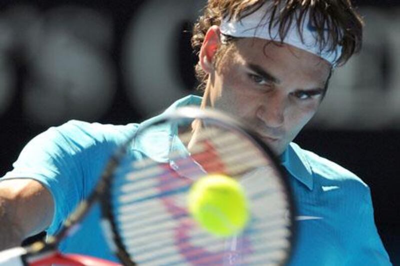 Swiss tennis player Roger Federer plays a backhand return during his men's singles match against Russian opponent Igor Andreev on the second day of play at the Australian Open tennis tournament in Melbourne on January 19, 2010.  Federer won 4-6. 6-2. 7-6. 6-0. The Australian Open is taking place from January 18-31.   AFP PHOTO/Greg WOOD