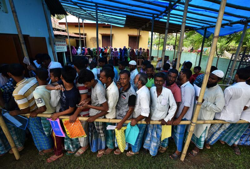 People wait in queue to check their names on the draft list at the National Register of Citizens (NRC) centre at a village in Nagaon district, Assam state, India, July 30, 2018. REUTERS/Stringer
