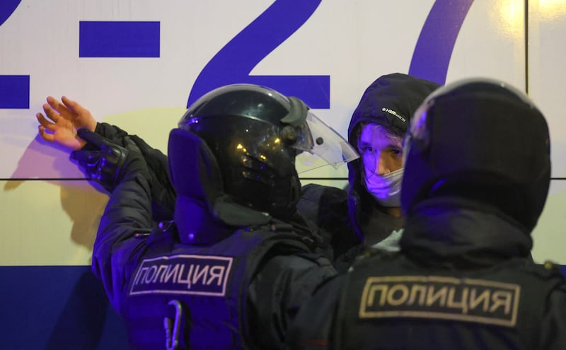 Russian police officers detain a person during an unsanctioned rally. Reuters