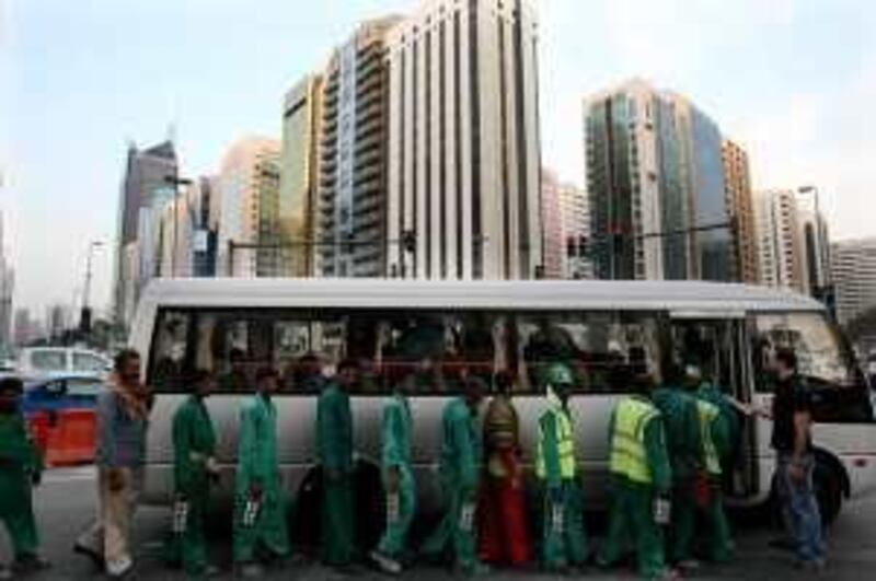 Abu Dhabi - 27th August  ,  2008 -Labours queue to get on buses to take them home after a long day on a building site in Central Abu Dhabi   ( Andrew Parsons  /  The National ) *** Local Caption ***  ap004-2708-labour bus.jpgap004-2708-labour bus.jpg