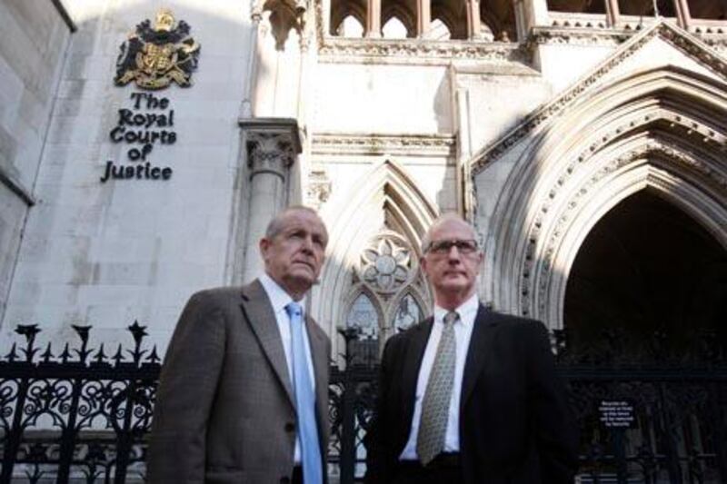 Victim's family members Sean Cassidy, left, and Graham Foulkes pose for the media as they arrive at the High Courts in London for the start of the Inquests into the July 7, 2005 bombing of London's transport system, Monday, Oct. 11, 2010. Sean Cassidy's son Kieran and Graham Foulkes' son David were killed in the terrorist attack on London's transport system. A long-delayed inquest into the July 7, 2005, suicide bombings that killed 52 people on London's transit network opened Monday with a minute's silence in memory of the victims.(AP Photo/Sang Tan)