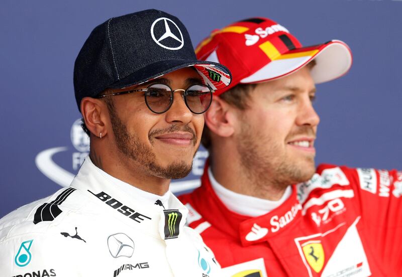 F1 - Formula One - British Grand Prix 2017 - Silverstone, Britain - July 15, 2017   Mercedes' Lewis Hamilton celebrates pole position after qualifying with Ferrari's Sebastian Vettel   REUTERS/Andrew Boyers