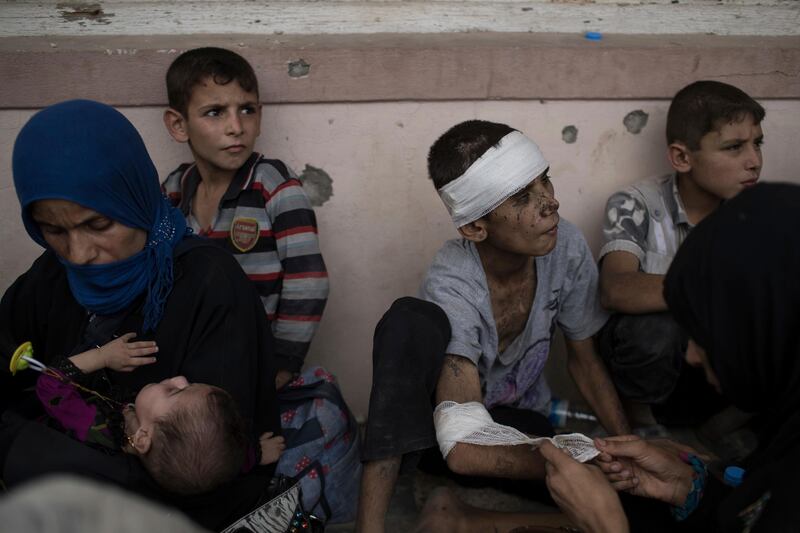 
                  <p>Fleeing Iraqi civilians sit inside a house as they wait to be taken out of the Old City during fighting between Iraqi forces and Islamic State militants in Mosul, Iraq, Saturday, July 8, 2017. (AP Photo/Felipe Dana)</p>
               