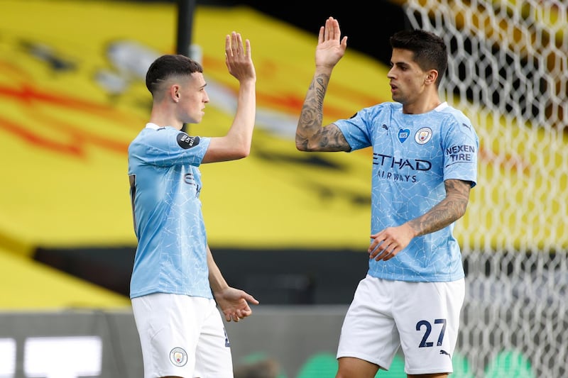 Phil Foden, left, of Manchester City celebrates with Joao Cancelo after scoring. EPA