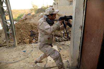 An Iraqi soldier aims his rifle during the battle against ISIS for Mosul in 2016. Reuters