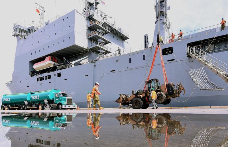 Emergency relief supplies and equipment for those affected by Cyclone Debbie are loaded onto the Royal Australian Navy Ship HMAS Choules at the Port of Brisbane in Australia, March 29, 2017.   AAP/Dave Hunt/via Reuters