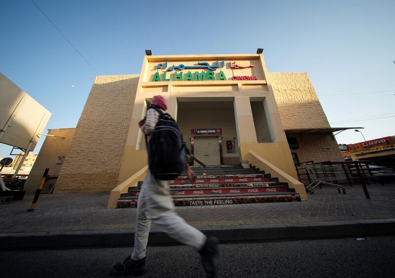 A man walks in front of a closed Al Hamra Cinema in Manama, Bahrain. Reuters