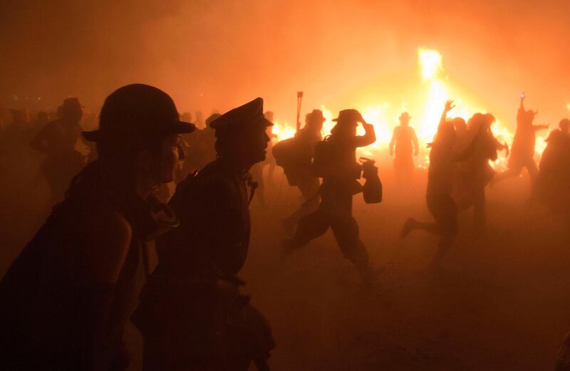 Participants run towards the fire after The Man was burned during the Burning Man 2011 "Rites of Passage" arts and music festival in the Black Rock desert of Nevada, September 3, 2011. More than 50,000 people from all over the world have gathered at the sold out festival which is celebrating its 25th year.    REUTERS/Jim Urquhart  (UNITED STATES - Tags: SOCIETY) FOR EDITORIAL USE ONLY. NOT FOR SALE FOR MARKETING OR ADVERTISING CAMPAIGNS. NO THIRD PARTY SALES. NOT FOR USE BY REUTERS THIRD PARTY DISTRIBUTORS *** Local Caption ***  SLC35_USA-_0904_11.JPG