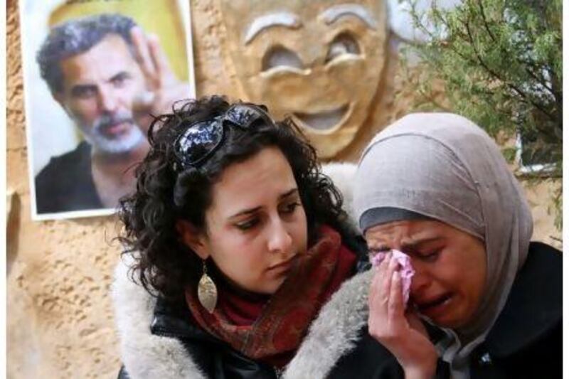 Palestinian women at the Freedom Theatre in Jenin weep after the death of the actor and director Juliano Mer-Khamis (inset).