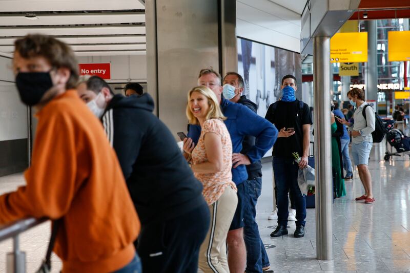 People wait for their loved ones to exit at arrivals in Heathrow Airport. Getty Images