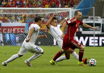 Andres Iniesta,right, of Spain in action with Alexis Sanchez centre, of Chile during their 2014 World Cup Group B match. Abedin Taherkenareh / EPA 