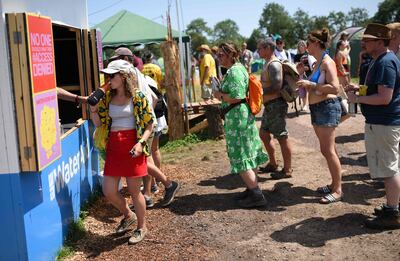 Revellers queue to fill their water bottles at a water re-filling station at the Glastonbury Festival of Music and Performing Arts on Worthy Farm near the village of Pilton in Somerset, South West England, on June 29, 2019.  - 
 / AFP / Oli SCARFF                          
