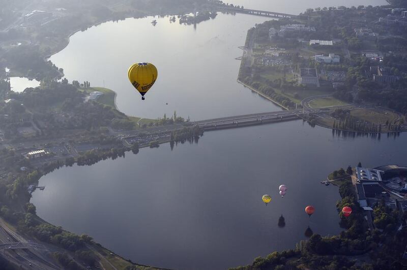 Hot air balloons are seen flying over Lake Burley Griffin at the canberra Balloon Festival in Canberra, Australia. This year marks the 30th anniversary of the Canberra Balloon Festival, considered one of the biggest hot air balloon festivals in the world. Lukas Coch / EPA