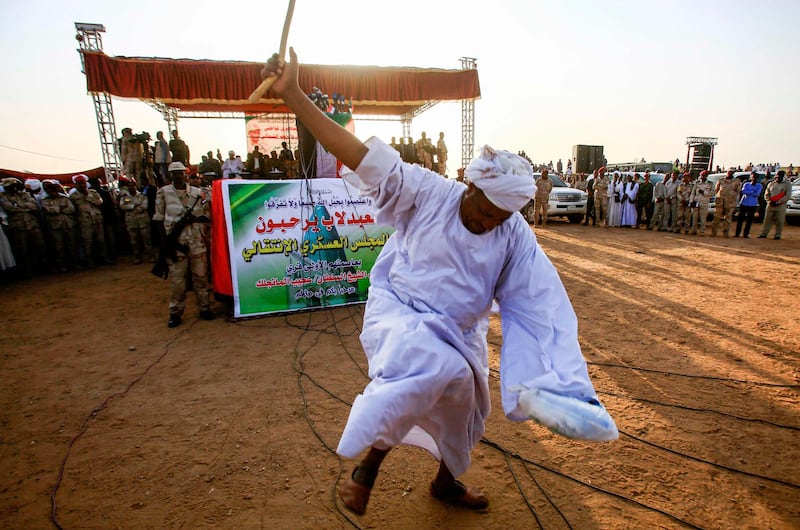 A supporter of the deputy head of Sudan's ruling Transitional Military Council (TMC) and commander of the Rapid Support Forces (RSF) paramilitaries dances to greet him upon his arrival in the village of Qarri, about 90 kilometres north of Khartoum.  AFP