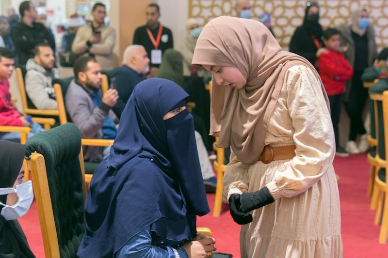 Ms Helmee, pictured standing, started learning the Quran with a tutor shortly after she turned three.