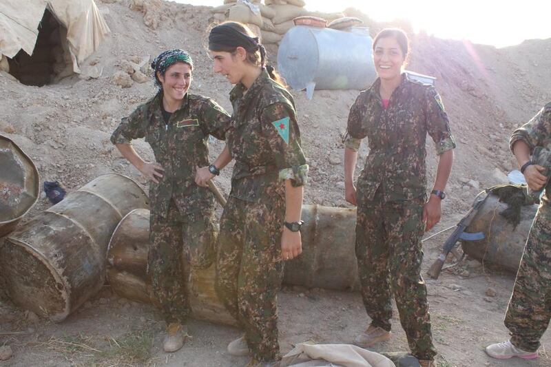 YPG fighters behind the berm that shields them from enemy fire.