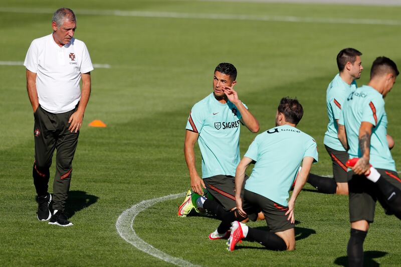 Portugal's Cristiano Ronaldo talks with coach Fernando Santos. AP