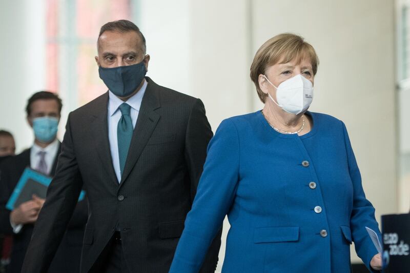 German Chancellor Angela Merkel and Iraqi Prime Minister Mustafa al-Kadhimi arrive for a news conference at the Chancellery in Berlin, Germany October 20, 2020. Stefanie Loos/Pool via REUTERS