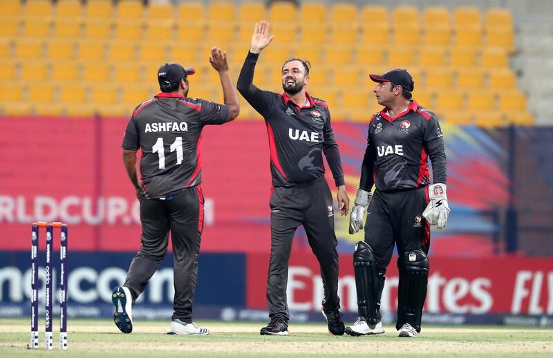 ABU DHABI , UNITED ARAB EMIRATES , October 19  – 2019 :- Rohan Mustafa ( center ) of UAE celebrating after taking the wicket of Mark Adair during the World Cup T20 Qualifiers between UAE v Ireland held at Zayed Cricket Stadium in Abu Dhabi.  ( Pawan Singh / The National )  For Sports. Story by Amith