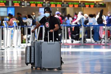 A man pushes his bags on the departures level at Los Angeles International Airport as people travel for Memorial Day weekend. Domestic travel markets in the US and China are rebounding ahead of international travel. AFP