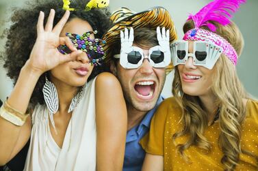 Buy fun props and hire a professional photographer to make your guests feel more special at your house party. Getty Images