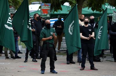 Protestors carry flags during a demonstration of the far-right party The Third Path (Der III. Weg) in Berlin, Germany, October 3, 2020. REUTERS/Christian Mang