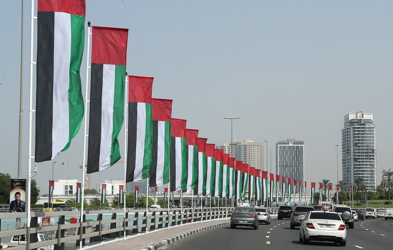 UAE flags lining a street in Dubai. Non-oil business activity has maintained a robust growth momentum this year. Pawan Singh / The National