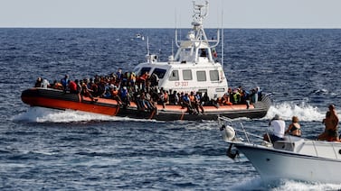An Italian Coast Guard boat carries migrants rescued at sea near the Sicilian island of Lampedusa, Italy, on September 18.  Reuters