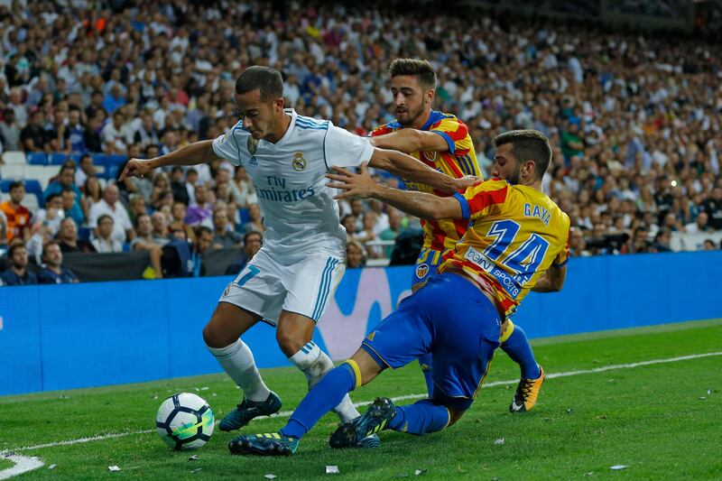 Real Madrid's Lucas Vazquez, left, battles for the ball with Valencia's Jose Luis Gaya, right, during a Spanish La Liga soccer match between Real Madrid and Valencia at the Santiago Bernabeu stadium in Madrid, Sunday, Aug. 27, 2017. The match ended in a 2-2 draw.(AP Photo/Francisco Seco)