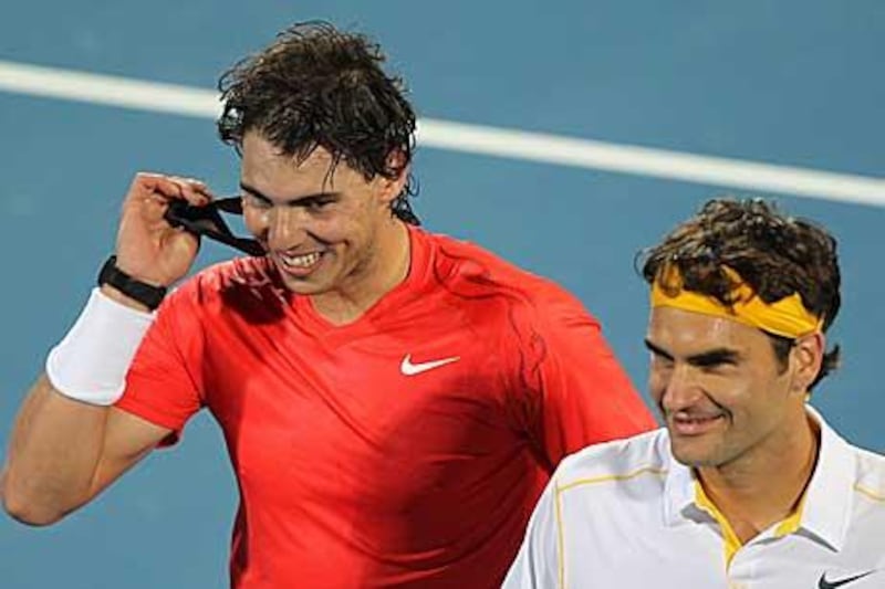 Rafael Nadal, left, and Switzerland's Roger Federer leave the court happy despite a tense final in Abu Dhabi.
