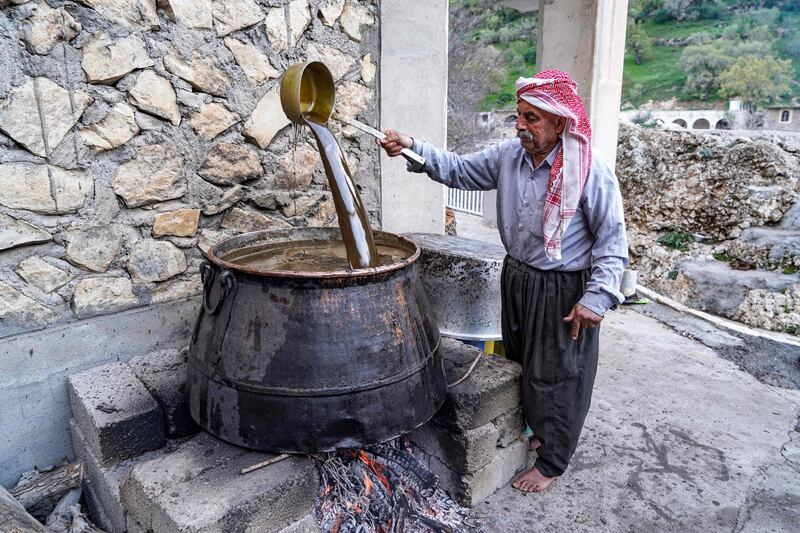 Pouring the freshly pressed olive oil into a boiling cauldron