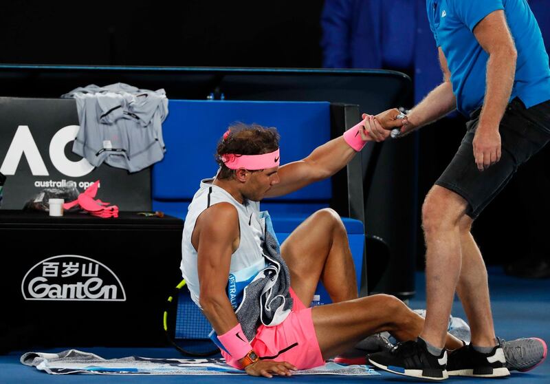 Tennis - Australian Open - Quarterfinals - Rod Laver Arena, Melbourne, Australia, January 23, 2018. Spain's Rafael Nadal receives medical attention during his match against Croatia's Marin Cilic. REUTERS/Issei Kato