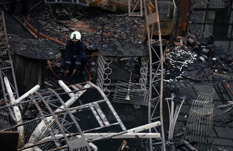 A firefighter goes through the debris of the restaurant. Danish Siddiqui / Reuters