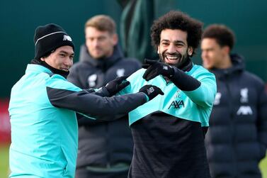 Liverpool's Takumi Minamino, left, and Mohamed Salah during a training session at Melwood training ground on Monday. PA