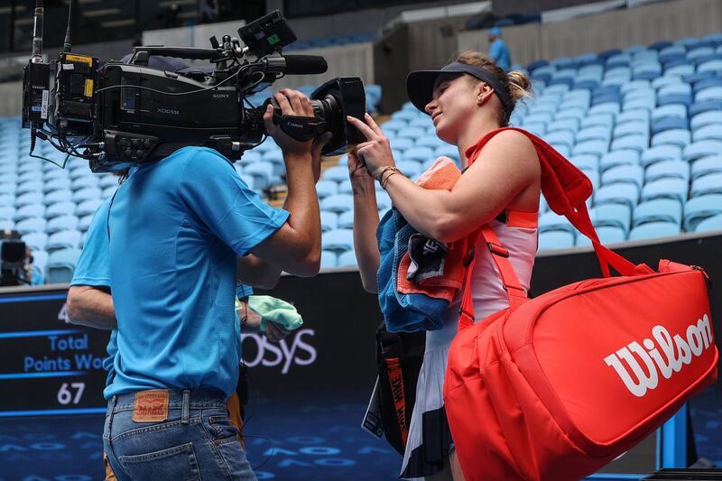 Ukrainian Elina Svitolina signs a television camera after her 6-4, 6-0 victory over Yulia Putintseva. AFP