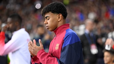 Barcelona's Spanish forward #27 Lamine Yamal prays as he enters the pitch during the UEFA Champions League quarter-final second leg football match between FC Barcelona and Paris SG at the Estadi Olimpic Lluis Companys in Barcelona on April 16, 2024.  (Photo by Josep LAGO  /  AFP)