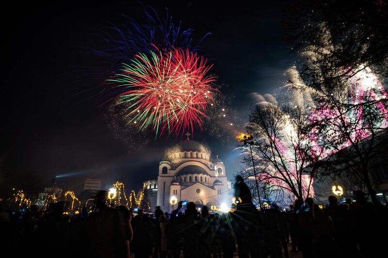 People watch as fireworks explode over Belgrade's Saint Sava Church to mark the Orthodox Christian New Year. AFP