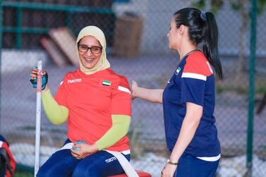 Dubai, United Arab Emirates, November 13, 2019. Sara Senaani practicing, shotput with her coach Naila at the Dubai Club for Peopleof Determination. She sits in a chair strapped in at the hips and one of herhands is tied to a pole – this is required otherwise she will topple over. Victor Besa / The National Section: NA Reporter: Ramola Talwar