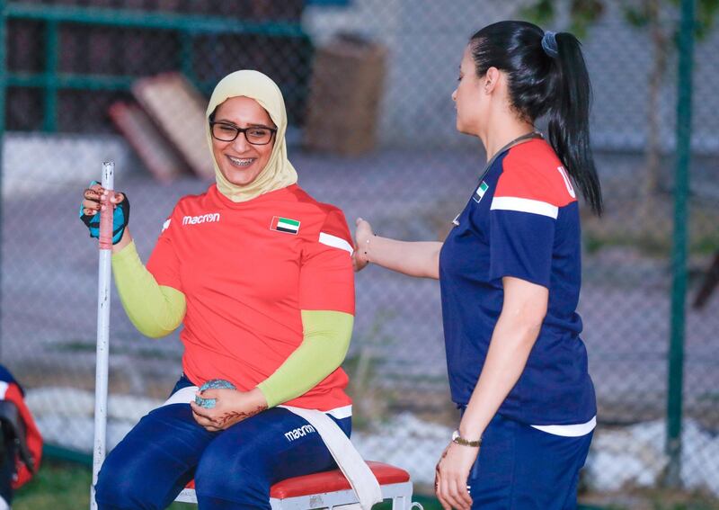 Dubai, United Arab Emirates, November 13, 2019.  
Sara Senaani practicing, shotput with her coach Naila at the Dubai Club for Peopleof Determination.  She sits in a chair strapped in at the hips and one of herhands is tied to a pole – this is required otherwise she will topple over.  
Victor Besa / The National
Section:  NA
Reporter:  Ramola Talwar