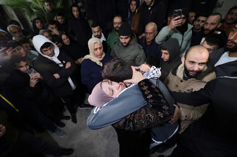 Palestinian detainee Khalil Zama hugs his mother after being released from an Israeli jail on Sunday. AFP