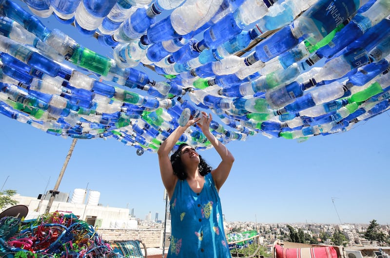 Maria Nissan, an environmental activist and artist, creates an art installation from plastic waste collected from the streets, in Amman, Jordan. All photos: AFP